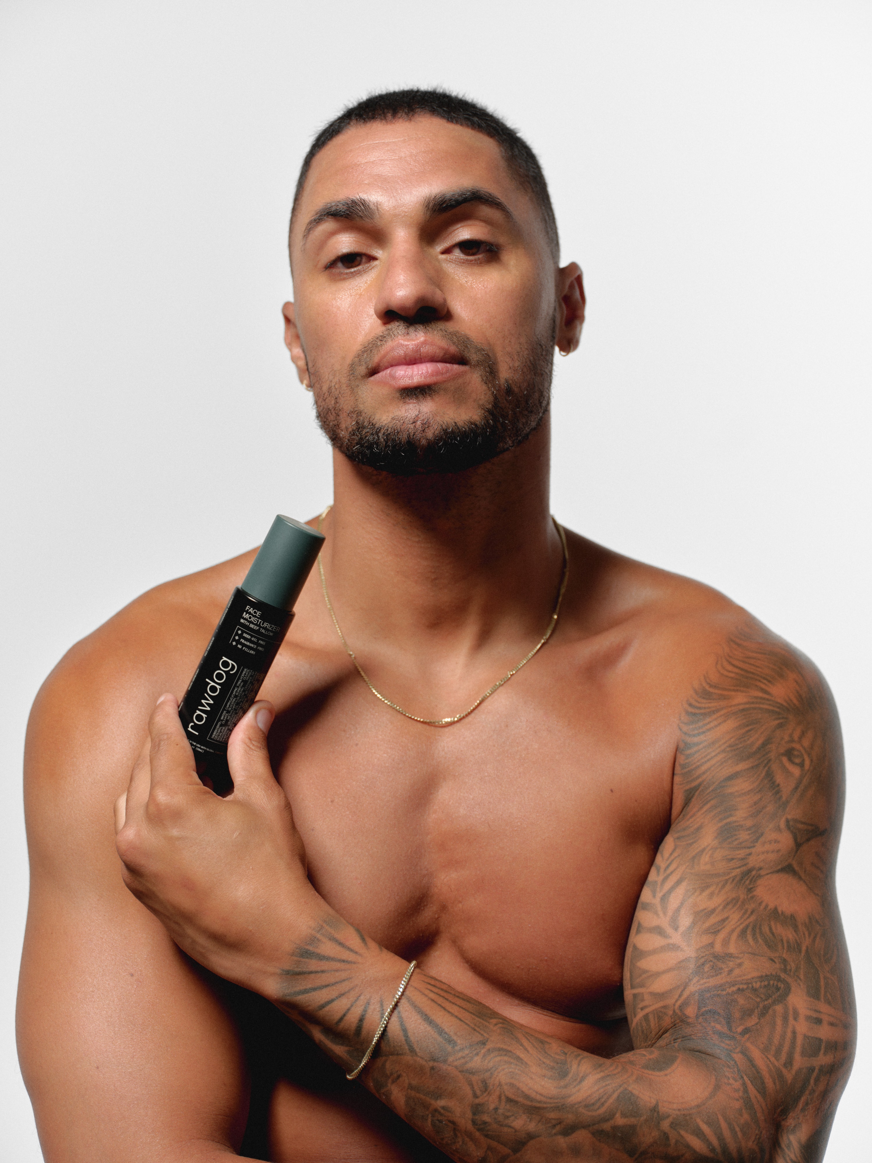 Model holding RAWDOG Face Moisturizer