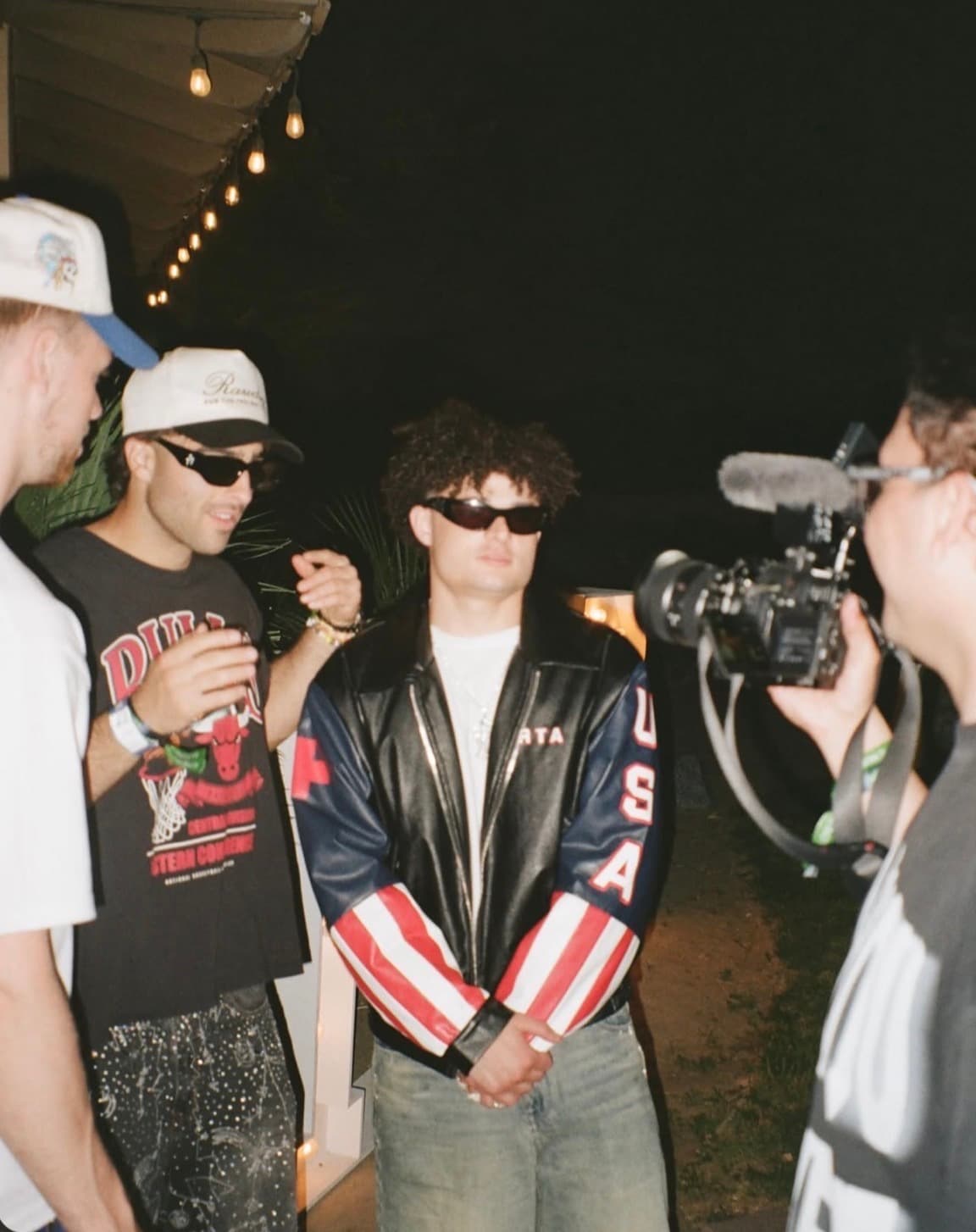 RAWDOG community members wearing trucker hats at an outdoor event
